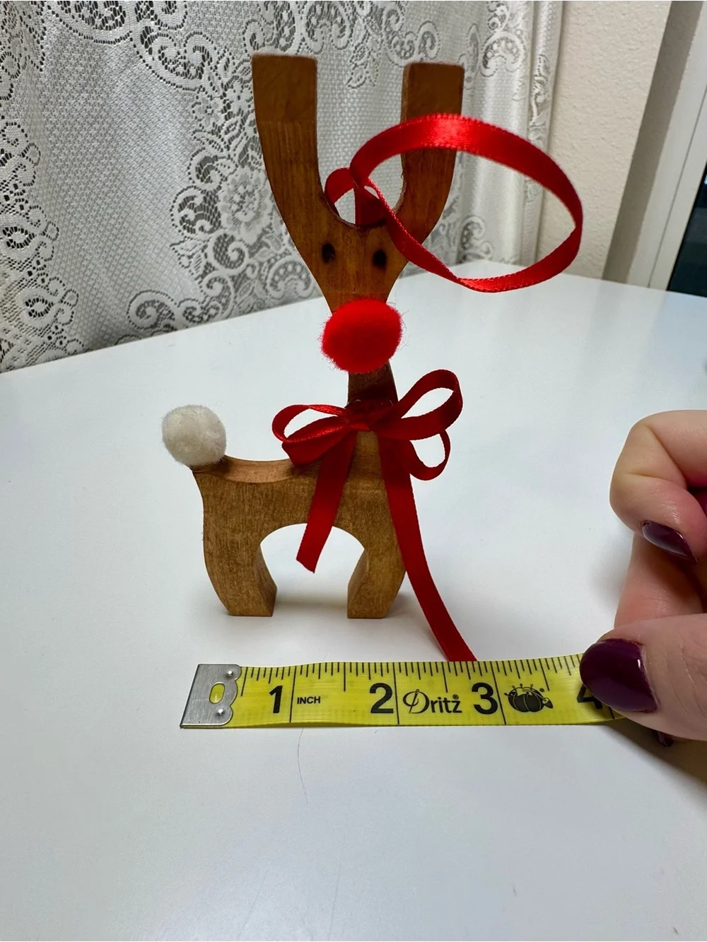 Homemade Wooden Reindeer Holiday Décor with Red Ribbon and Pom-Poms